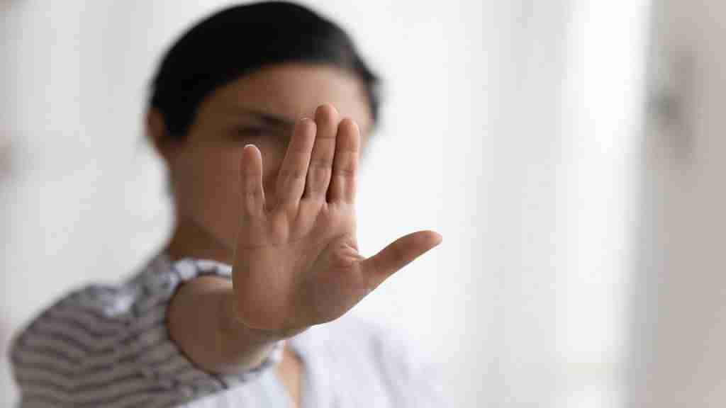 Breakaway, woman holding up hand to stop