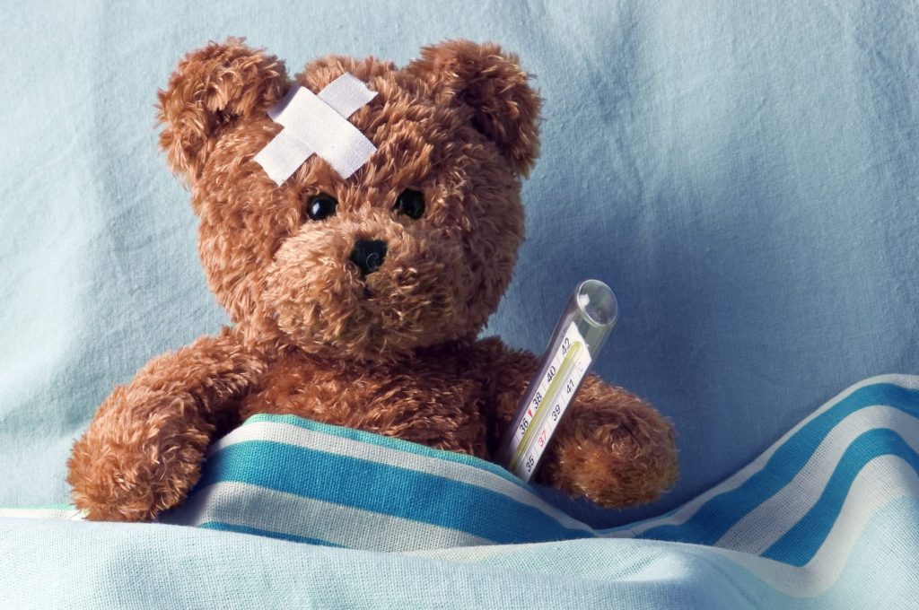 Paediatric First Aid Level 3, teddy bear in bed with plaster and thermometer.
