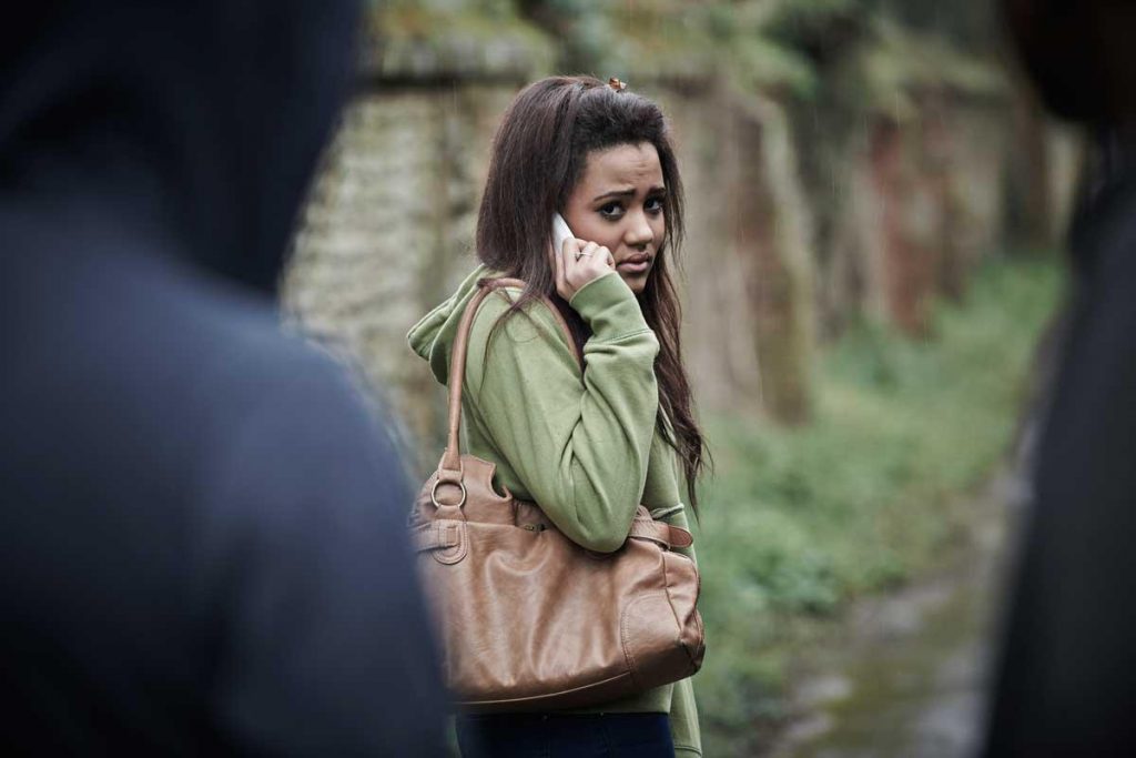Personal Safety, Long worker being followed home, looking distressed on mobile.