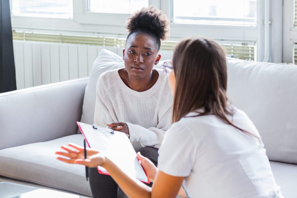patient receiving bad news, she is desperate and crying, doctor support and comforting her patient with sympathy. don't worry, this medical test is not so bad