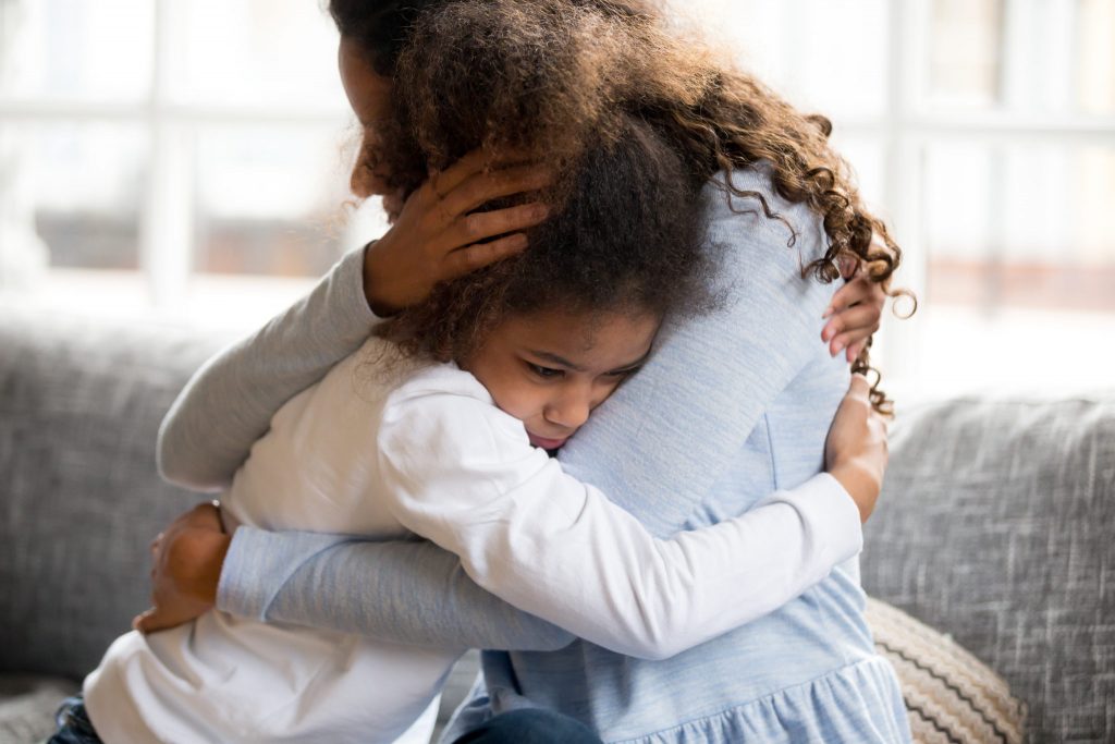 PTSD Children, young girl hugging mother.