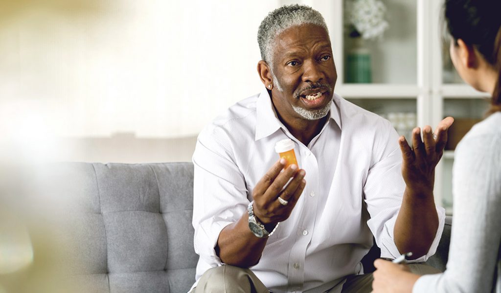 Administration of Medication man holding medicine