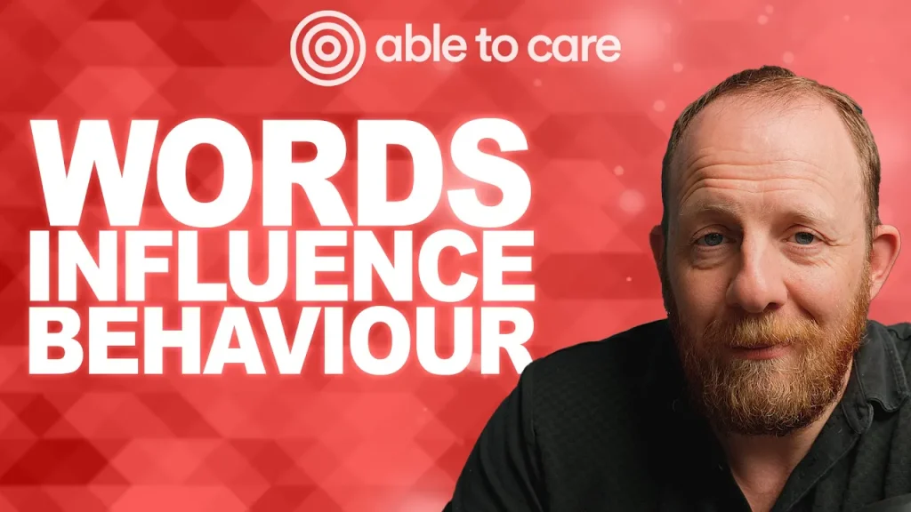 Headshot of andy baker on red background with the Able to Care logo and text ''words influence behaviour''
